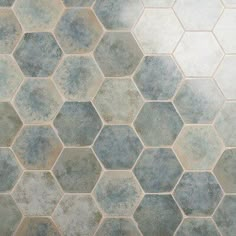 a tile floor with hexagonal tiles in blue and grey colors on the ground