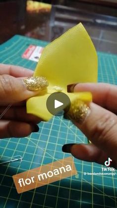 someone is making something out of yellow paper