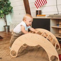 a small child playing with a wooden wheel