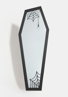 a mirror that has spider webs on the front and back of it, hanging from a wall