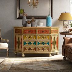 a living room with an ornate dresser and chair