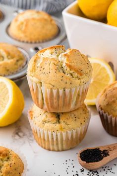 lemon poppy seed muffins stacked on top of each other next to sliced lemons