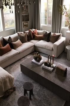 a living room filled with lots of furniture next to a window covered in chandelier