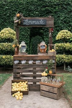 an outdoor lemonade stand with wooden crates filled with lemons