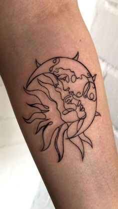 a woman's arm with a sun and moon tattoo on it