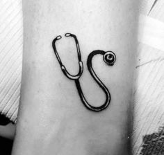 a black and white photo of a stethoscope tattoo on the arm with a doctor's stethoscope