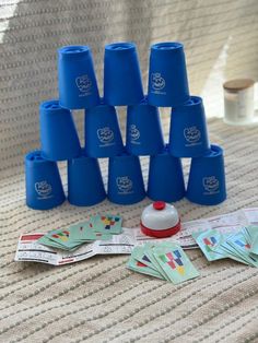 a group of blue cups sitting next to each other on top of a table covered in stickers