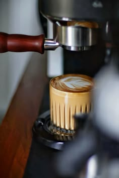 a cappuccino being made from a coffee machine