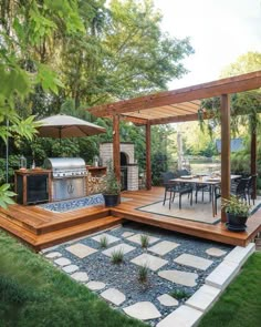 an outdoor kitchen and dining area in a backyard