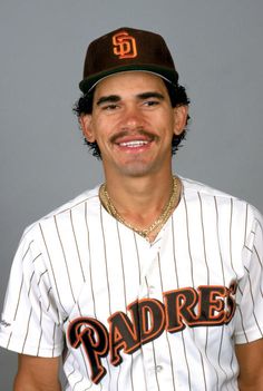 a man in a baseball uniform is smiling