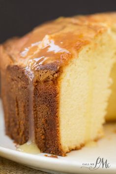 a piece of cake on a white plate with caramel drizzle and icing