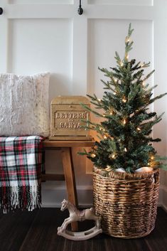 a small christmas tree sitting next to a basket