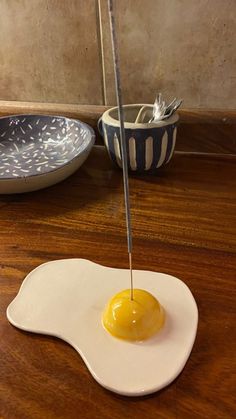 an egg yolk is being drizzled onto a plate with a spoon