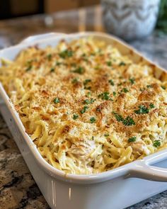 a casserole dish with chicken and parmesan cheese in it on a table