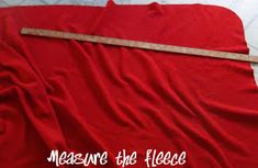 there is a red sheet with a measuring tape on top of it that says measure the fleece