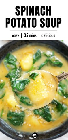 spinach potato soup in a black bowl with a spoon