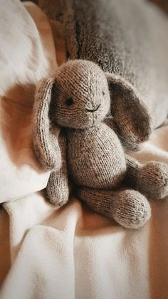 a stuffed animal sitting on top of a bed