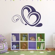 a child's room with a bookcase and wall decal in the shape of a butterfly