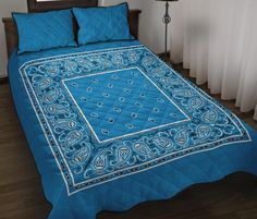 a blue bedspread on a bed in a room