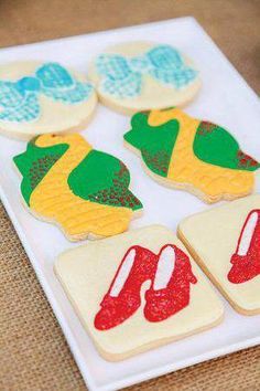 decorated cookies on a white plate sitting on a table