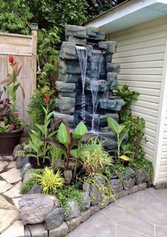 a small waterfall in the middle of a garden