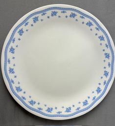 a blue and white plate on a gray surface with an empty fork next to it