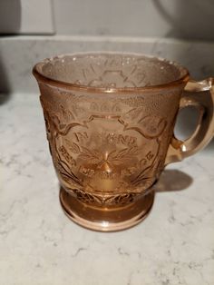 a glass cup sitting on top of a counter