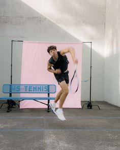 a tennis player is jumping in the air with his racket