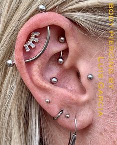 a woman with some piercings on her ear