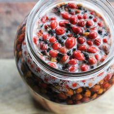 a jar filled with lots of food on top of a table