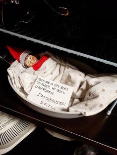 there is a baby doll in the oven with a sign on it that says, belong to each other