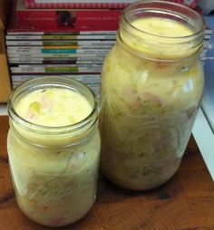 two jars filled with food sitting on top of a table