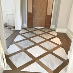 an empty room with wooden doors and tile flooring in the process of being painted