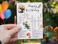 a person holding up a crossword puzzle card for a child's birthday party