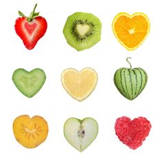 various fruits are arranged in the shape of heart shaped pieces on a white background, including kiwi, orange, apple, and strawberry