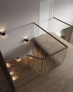 an overhead view of a staircase with wooden handrails and glass balconies