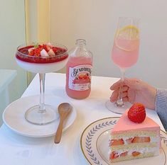 a person sitting at a table with two desserts on it and a drink in front of them