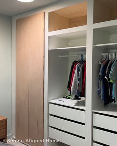 an empty closet with clothes hanging on the shelves