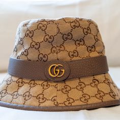 Made In Italy. Crafted From Monogram Canvas, This Bucket Hat Is Completed By A Tonal Leather Trim. Enhanced By The Historic Double G Detail On The Side, Both The Archival References And The Shape Speak To The Vintage Feel That Permeates The House's Design Narrative. Add This Stylish Authentic Hat To Your Wardrobe. Gucci Bucket Hat Women, Gucci Accessories, Hat Sizes, Monogram Canvas, The Vintage, Leather Trims, Bucket Hat, In Italy, Monogram