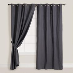 the curtain is open and ready to be hung in front of a window with black curtains