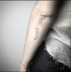 a woman's arm with a small tattoo on the left side of her arm