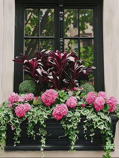 a window box filled with pink flowers and green plants