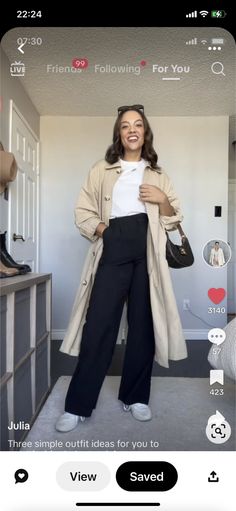 a woman is taking a selfie with her cell phone while wearing black pants and a white t - shirt