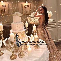 a woman standing next to a table with candles