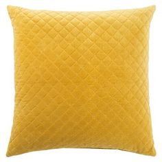 a yellow pillow with diamond quilting on the front and back, against a white background