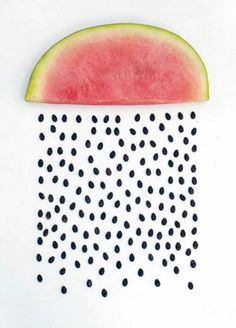 a slice of watermelon with black dots on it