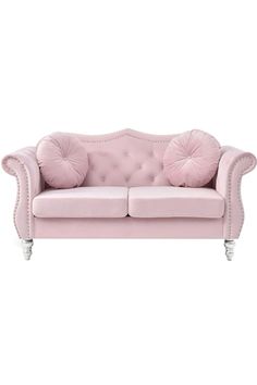 a pink couch sitting on top of a white floor