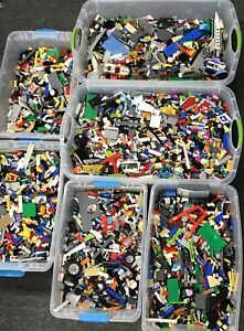 several plastic containers filled with legos on top of a black table next to each other