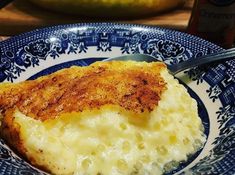 a blue and white plate topped with mashed potatoes