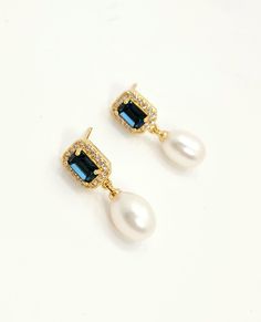 Soft white fresh water pearl oval drop with emerald rectangle cut Montana navy blue or emerald green crystal centered gold plated post earrings with cubic deco. Size: 2.5cm x .8cm Average Pearl size 8mmx10mm (+ - 1mm) Due to the nature of natural pearl, shape, color and size may vary from picture shown. . Returns and exchange details   Customer Satisfaction Guarantee: Below policy will replace standard ETSY policy- please read carefully before purchasing. If you are not satisfied with an item fo Elegant Rectangular Jewelry For Anniversary, Elegant Gold Plated Rectangular Earrings, Elegant Rectangular Pearl Drop Earrings, Elegant Blue Pearl Earrings, Elegant Emerald Cut Earrings, Blue Pearl Charm Drop Earrings, Exquisite Pearl Drop Jewelry, Elegant Oblong Gemstone Jewelry, Exquisite Oval Pearl Drop Jewelry